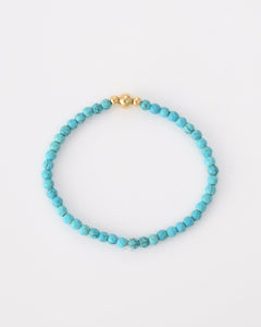 Turquoise kralen armband met drie goudkleurige balletjes - Nouka